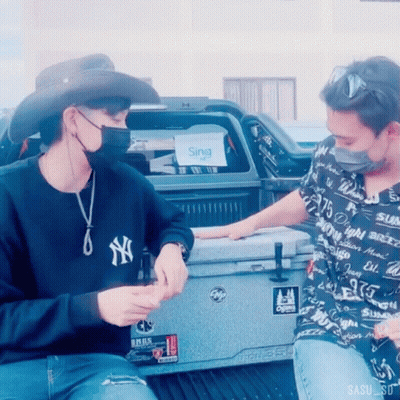 A Man Wearing A Ny Yankees Sweatshirt Sits Next To Another Man GIF
