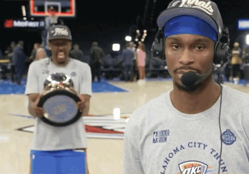 A Man Wearing A Oklahoma City Thunder T-Shirt Holds A Trophy GIF