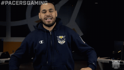 A Man Wearing A Pacers Gaming Hoodie Stands In Front Of A Black Background GIF
