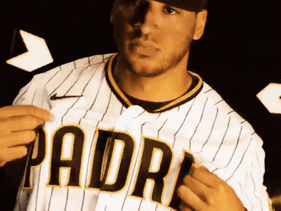 A Man Wearing A Padres Jersey Is Holding A Piece Of Paper GIF
