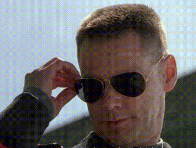 A Man Wearing A Pair Of Aviator Sunglasses Adjusts His Glasses GIF