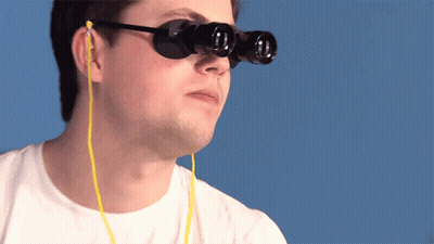 A Man Wearing A Pair Of Binoculars With Ear Buds Attached To Them GIF