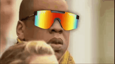 A Man Wearing A Pair Of Colorful Sunglasses Is Looking At A Woman . GIF