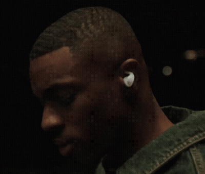 A Man Wearing A Pair Of Ear Buds With The Letter O On Them GIF