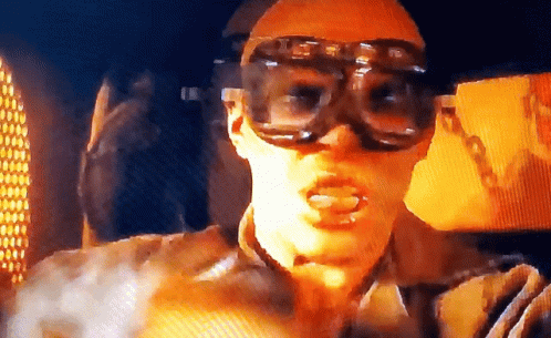A Man Wearing A Pair Of Goggles With The Letter G On Them GIF