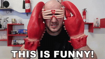 A Man Wearing A Pair Of Lobster Gloves Covering His Eyes GIF