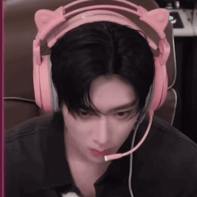 A Man Wearing A Pair Of Pink Headphones With A Microphone . GIF