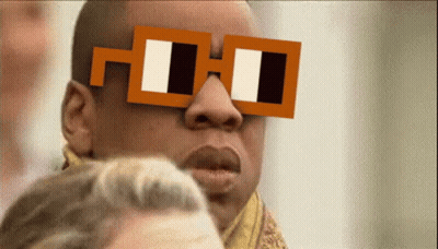 A Man Wearing A Pair Of Square Glasses With The Letter H On It GIF