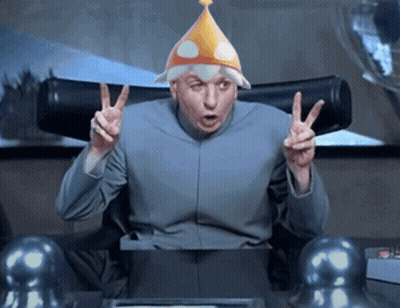A Man Wearing A Party Hat Giving The Peace Sign GIF