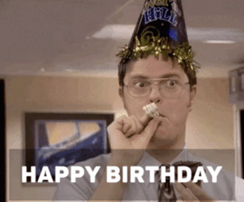 A Man Wearing A Party Hat Is Blowing A Party Horn While Eating A Cake .. GIF