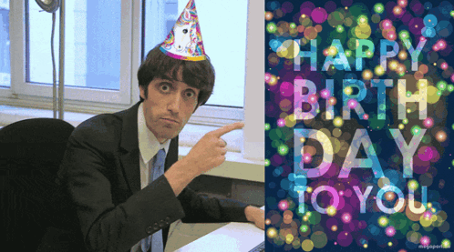 Man In Party Hat Pointing At Happy Birthday Card GIF