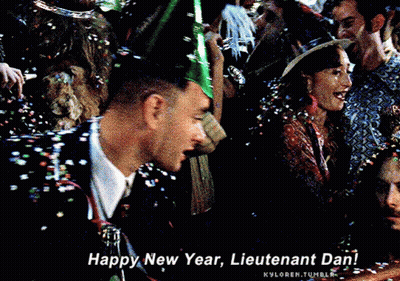 A Man Wearing A Party Hat Is Surrounded By Confetti And Says Happy New Year Lieutenant Dan GIF