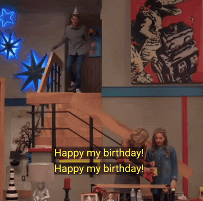A Man Wearing A Party Hat Is Walking Down A Set Of Stairs And Says " Watch Out Watch Out For What " GIF