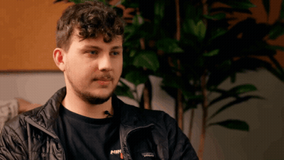 A Man Wearing A Patagonia Jacket And A Shirt With The Word Min On It GIF