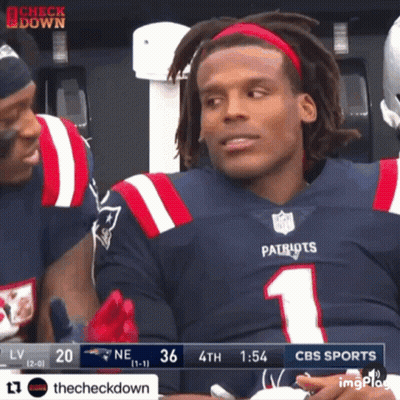 A Man Wearing A Patriots Jersey Is Sitting In The Stands GIF