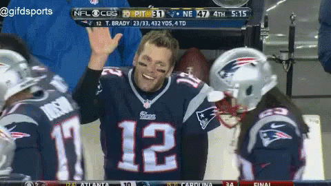 A Man Wearing A Patriots Jersey With The Number 12 On It Is Giving A High Five GIF