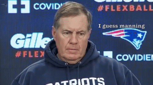 A Man Wearing A Patriots Sweatshirt Stands In Front Of A Gillette Advertisement GIF