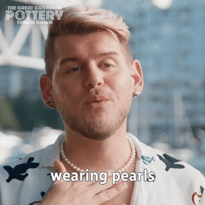 A Man Wearing A Pearl Necklace With The Words Wearing Pearls Written On It GIF