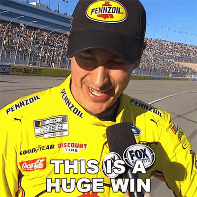 A Man Wearing A Pennzoil Hat Is Smiling While Holding A Microphone GIF
