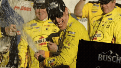 A Man Wearing A Pennzoil Shirt Celebrates With His Team GIF