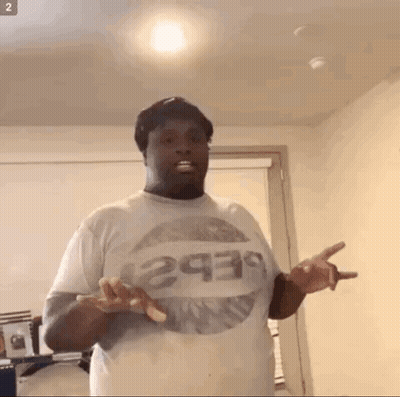 A Man Wearing A Pepsi T-Shirt Is Standing In A Room GIF