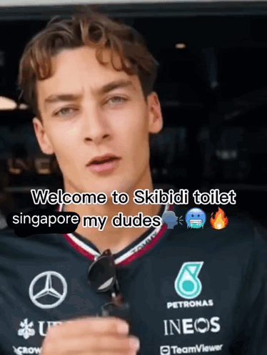 A Man Wearing A Petronas Shirt Says Welcome To Skibidi Toilet GIF