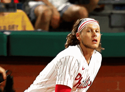 A Man Wearing A Phillies Jersey With A Headband On GIF