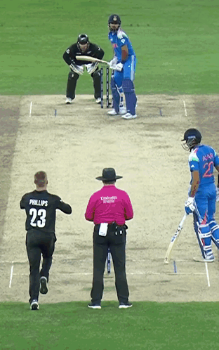 A Man Wearing A Phillips 23 Jersey Is Running Towards A Cricket Player GIF