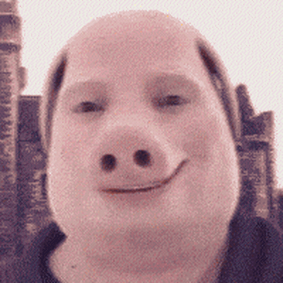 A Man Wearing A Pig Mask Smiles In Front Of A Building GIF