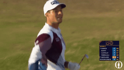 A Man Wearing A Ping Hat And A Cisco Sweater Stands In A Field GIF