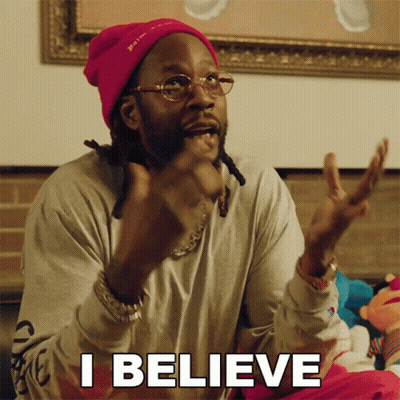 A Man Wearing A Pink Beanie And Glasses Is Saying I Believe GIF