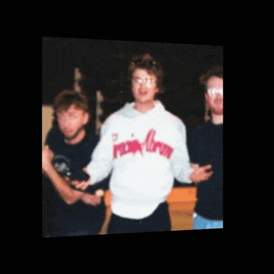 A Man Wearing A Pink Crown Sweatshirt Stands In A Group Of People GIF