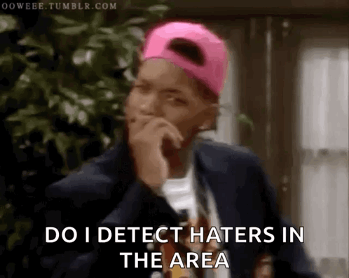 A Man Wearing A Pink Hat And A Suit Says Do I Detect Haters In The Area GIF