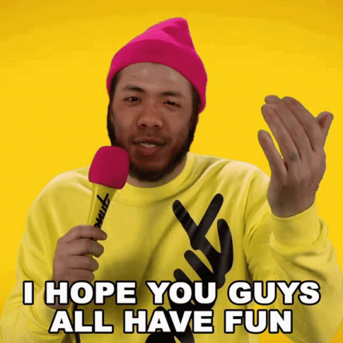 A Man Wearing A Pink Hat And A Yellow Sweater Holds A Pink Microphone And Says I Hope You Guys All Have Fun GIF