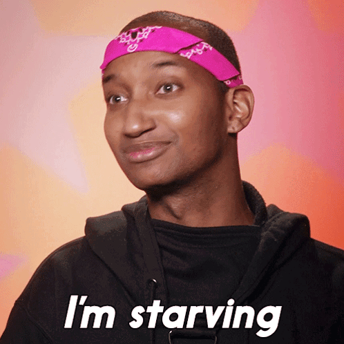 a man wearing a pink headband and a black hoodie says i 'm starving