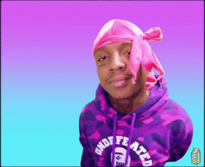A Man Wearing A Pink Headband And A Purple Hoodie With The Word Undefeated On It GIF