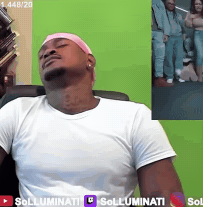 A Man Wearing A Pink Headband Sits In Front Of A Green Screen That Says Sollumini GIF