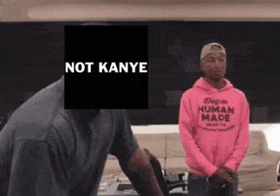 A Man Wearing A Pink Human Made Sweatshirt Stands Next To Another Man GIF