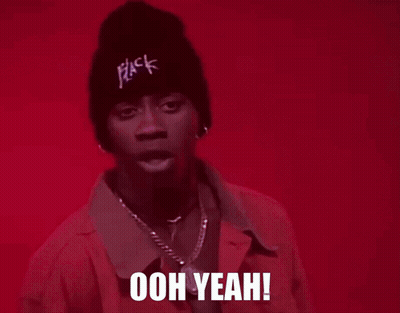 A Man Wearing A Pink Jacket And A Black Beanie Is Saying Ooh Yeah GIF