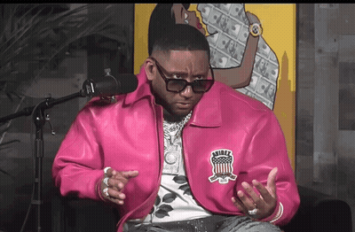 A Man Wearing A Pink Jacket With The Word Rider On The Back GIF
