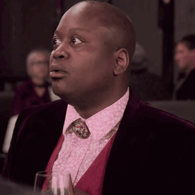 A Man Wearing A Pink Shirt And A Purple Jacket GIF