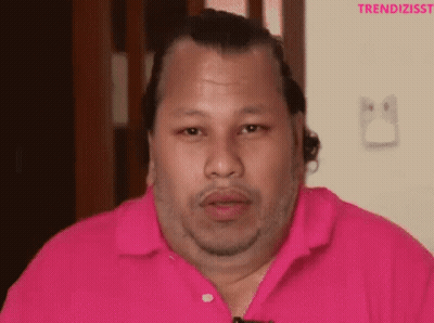 A Man Wearing A Pink Shirt With The Word Trendizisst On The Bottom Right GIF