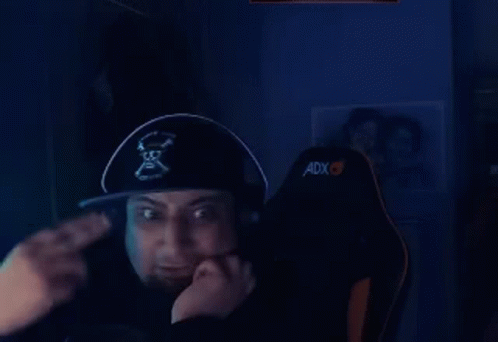 A Man Wearing A Pirate Hat And Headphones Is Sitting In A Chair And Giving A Thumbs Up . GIF
