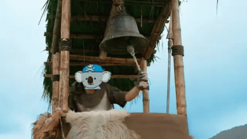 A Man Wearing A Pirate Hat Is Ringing A Bell In A Tower . GIF