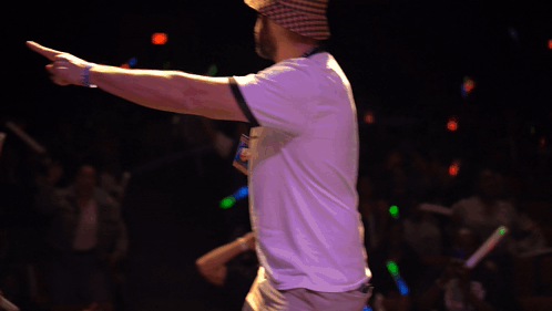 A Man Wearing A Plaid Hat And A White Shirt Is Pointing GIF