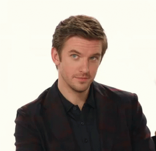 A Man Wearing A Plaid Jacket And A Black Shirt Is Making A Funny Face GIF