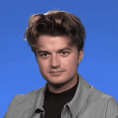 A Man Wearing A Plaid Jacket And Black Shirt Is Making A Face GIF