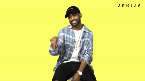 A Man Wearing A Plaid Shirt And A Black Hat With The Word Genius On The Bottom Right GIF