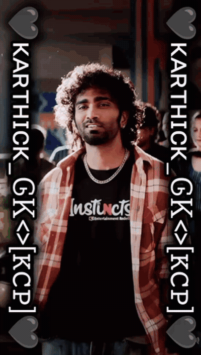 A Man Wearing A Plaid Shirt And A Black Shirt With Instincts On It GIF