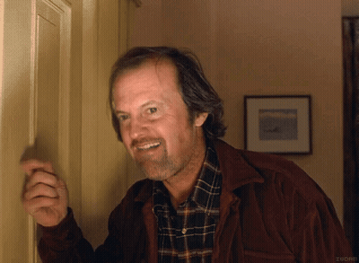 A Man Wearing A Plaid Shirt And A Brown Jacket Is Smiling GIF